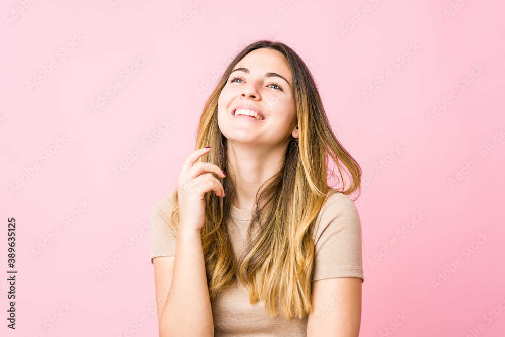 Young beautiful woman isolated on pink background Young beautiful woman isolated on pink background