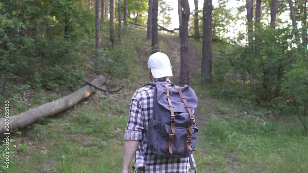 A young man walks in the woods. A young man walks in the woods.