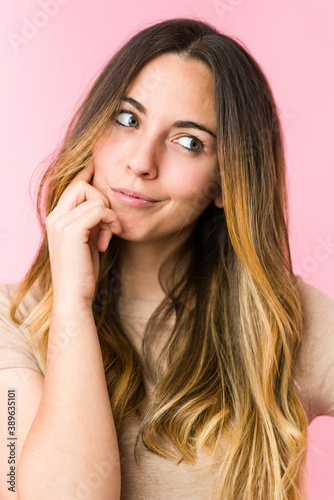 Young beautiful woman isolated on pink background