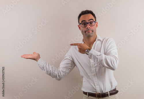 man with glasses and white shirt showing something that could be spectacular.