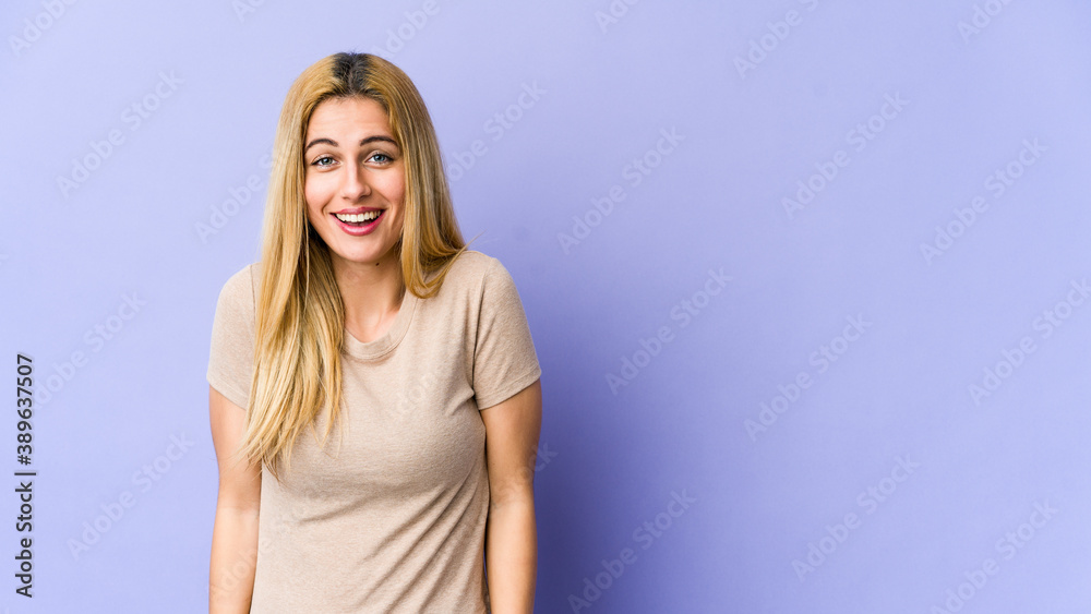 Young blonde caucasian woman laughs and closes eyes, feels relaxed and happy. Young blonde caucasian woman laughs and closes eyes, feels relaxed and happy.
