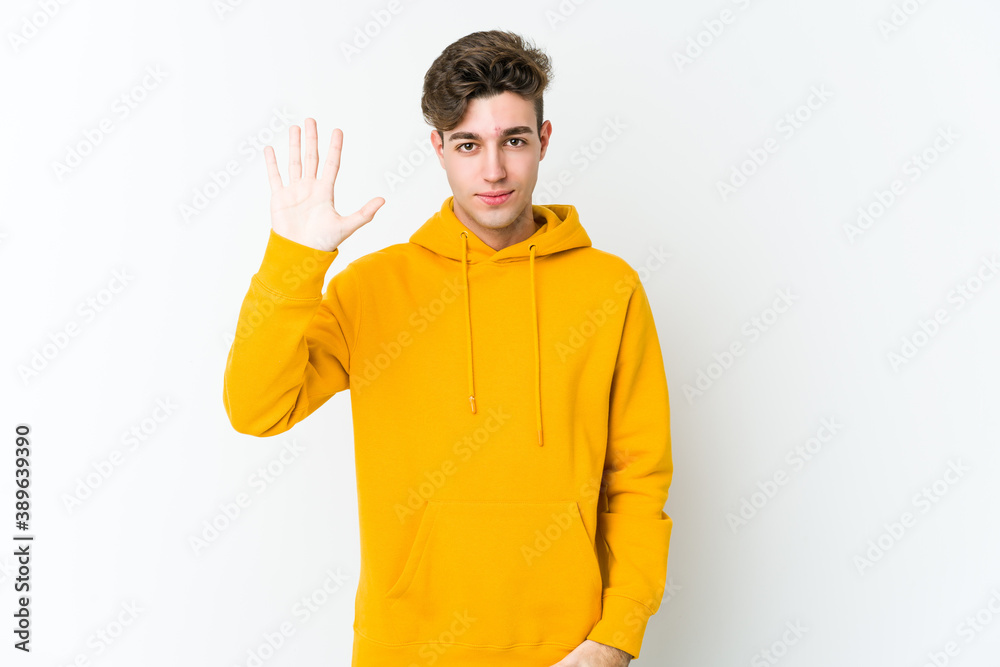 Young caucasian man isolated on white background smiling cheerful showing number five with fingers. Young caucasian man isolated on white background smiling cheerful showing number five with fingers.