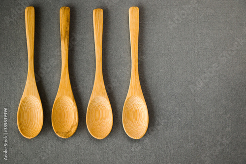 Empty wooden spoon on the gray background