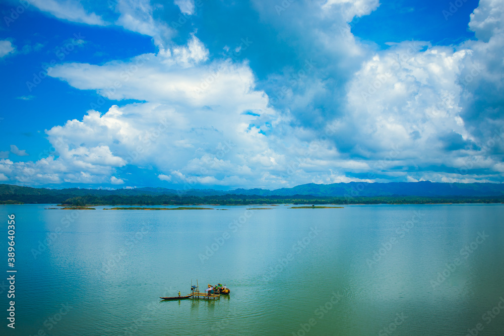 A boat resting in the middle of a lake A boat resting in the middle of a lake