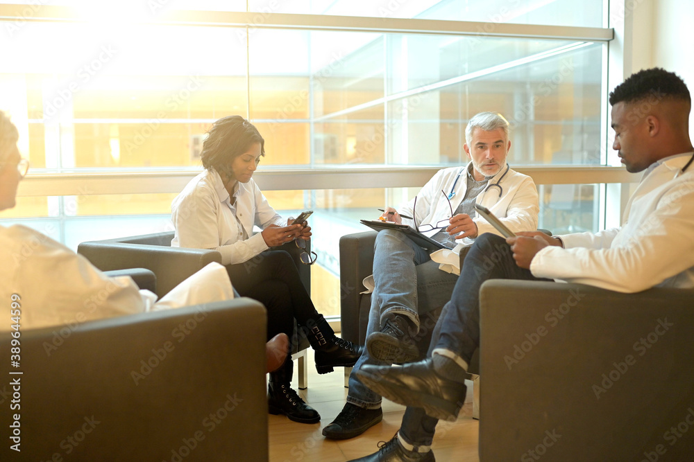 Medical people sitting in meeting room, checking planning together