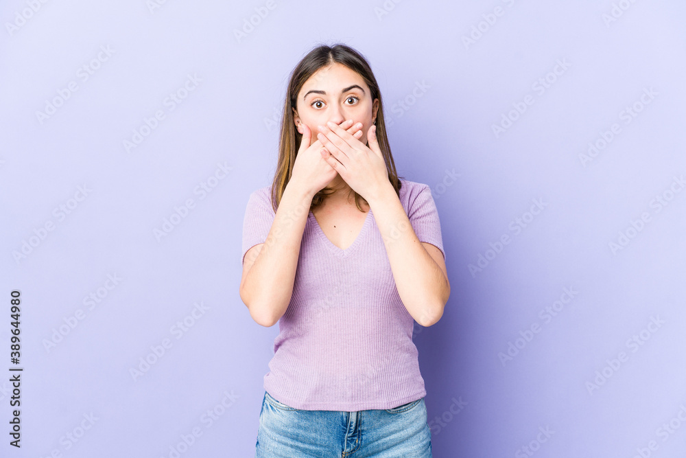 Young caucasian woman shocked covering mouth with hands. Young caucasian woman shocked covering mouth with hands.