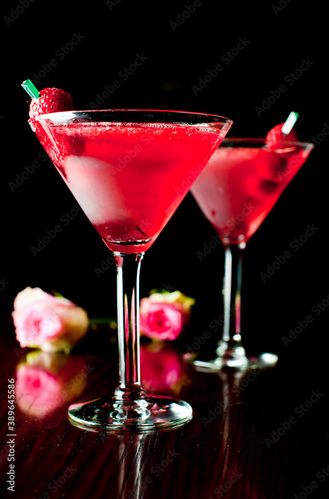 Cosmopolitan Cocktail. Action shot. Alcoholic Drinks made with gin, vodka, rum or whiskey mixed with soda water, fruit juices and garnishes with limes and cherries. Classic American bar drinks. Cosmopolitan Cocktail. Action shot. Alcoholic Drinks made with gin, vodka, rum or whiskey mixed with soda water, fruit juices and garnishes with limes and cherries. Classic American bar drinks.