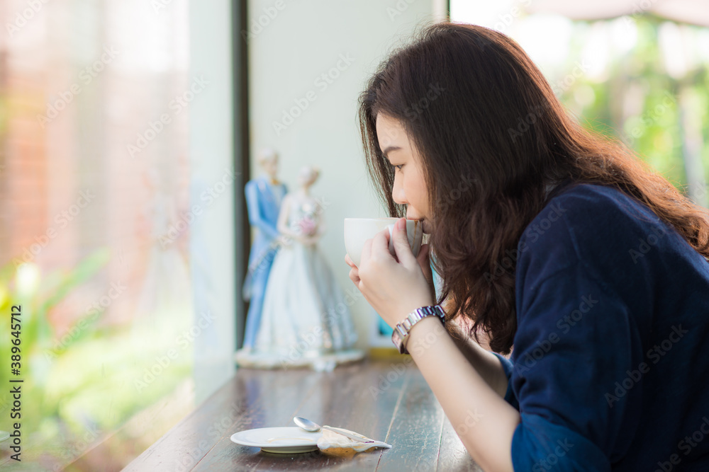 Business asian women sitting in cafe drinkking coffee Business asian women sitting in cafe drinkking coffee