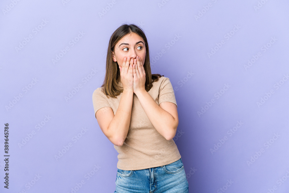 Young caucasian woman thoughtful looking to a copy space covering mouth with hand. Young caucasian woman thoughtful looking to a copy space covering mouth with hand.