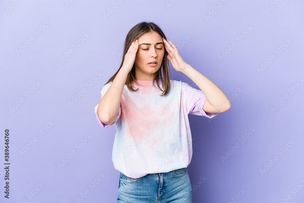 Young caucasian woman touching temples and having headache.