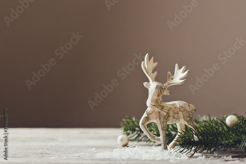 Christmas card conception. Christmas toy deer decoration with christmas tree branch and snow
