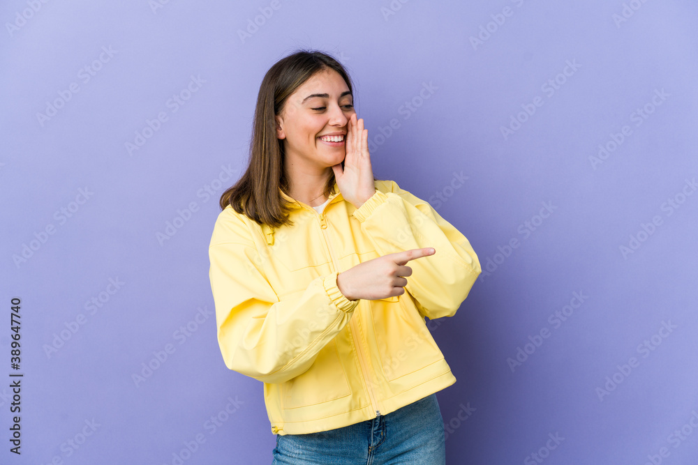 Young caucasian woman saying a gossip, pointing to side reporting something. Young caucasian woman saying a gossip, pointing to side reporting something.