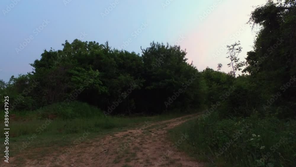 Walking along at dirt road. Nature at sunset. Hand held. Hungary, Europe. 4K Walking along at dirt road. Nature at sunset. Hand held. Hungary, Europe. 4K