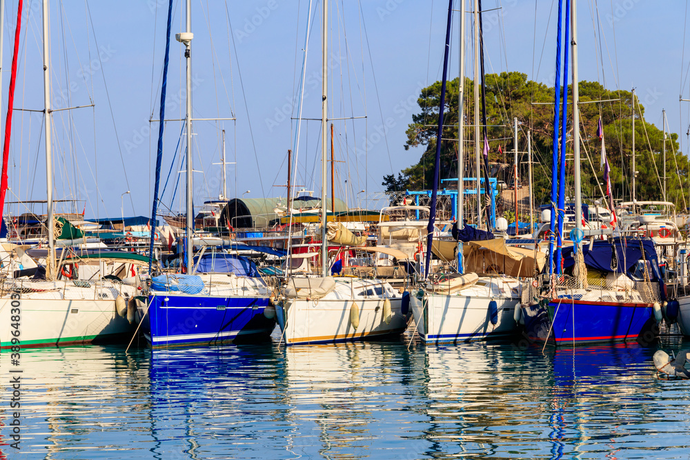 Obraz premium White yachts in the sea harbor of Kemer, Antalya province in Turkey. Kemer Marina on the Mediterranean sea
