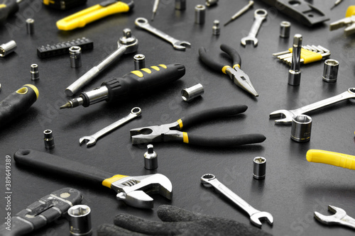 Many different tools for repair work on a black background.