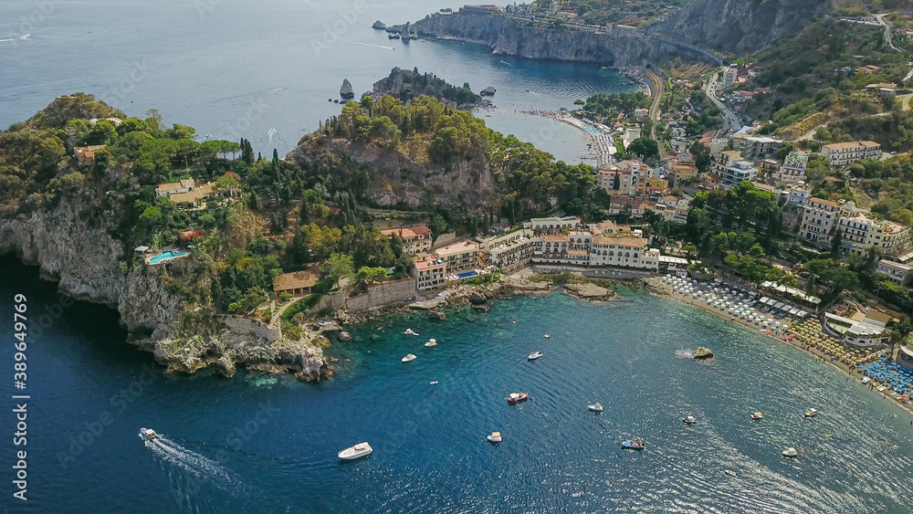 Naklejka premium View over the beaches of Taormina, Italy, with turquoise sea and a sunny sky