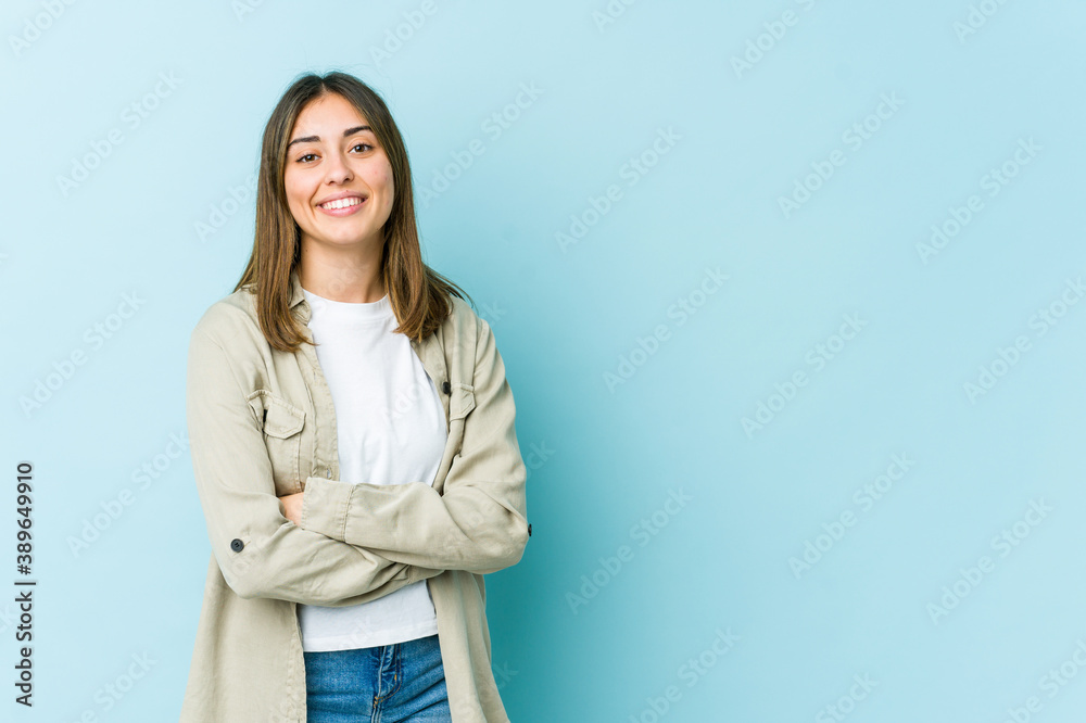 Young caucasian woman who feels confident, crossing arms with determination. Young caucasian woman who feels confident, crossing arms with determination.