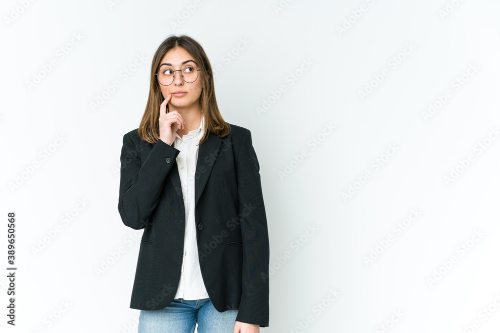 Young caucasian business woman looking sideways with doubtful and skeptical expression. Young caucasian business woman looking sideways with doubtful and skeptical expression.