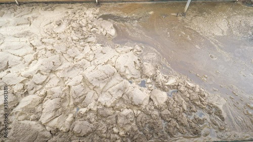 Sticky brown foam on slurry surface. Sewage treatment plant under city is clearing all waste water before being released into the river. photo