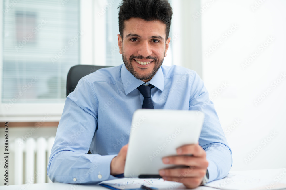 Businessman using a tablet in his office Businessman using a tablet in his office
