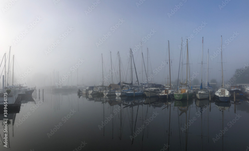 Harbor on a misty morning around the Sneekermeer
