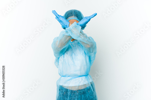 Young surgeon latin woman isolated on white background keeping two arms crossed, denial concept.
