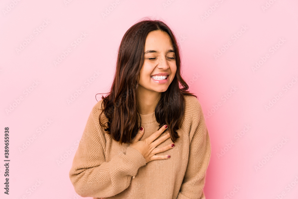 Young mixed race hispanic woman isolated laughing keeping hands on heart, concept of happiness. Young mixed race hispanic woman isolated laughing keeping hands on heart, concept of happiness.