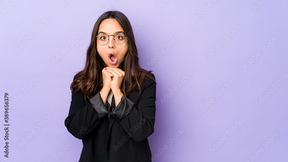 Young mixed race hispanic woman isolated praying for luck, amazed and opening mouth looking to front. Young mixed race hispanic woman isolated praying for luck, amazed and opening mouth looking to front.