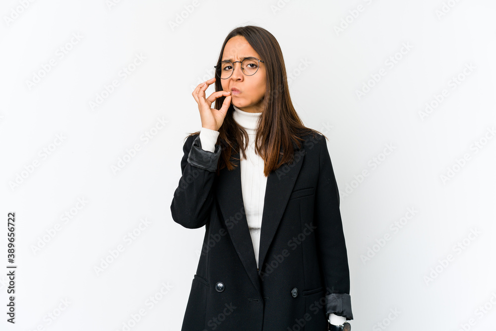 Young mixed race business woman isolated on white background with fingers on lips keeping a secret. Young mixed race business woman isolated on white background with fingers on lips keeping a secret.