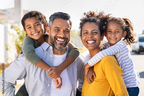 Multiethnic parents giving children piggyback ride