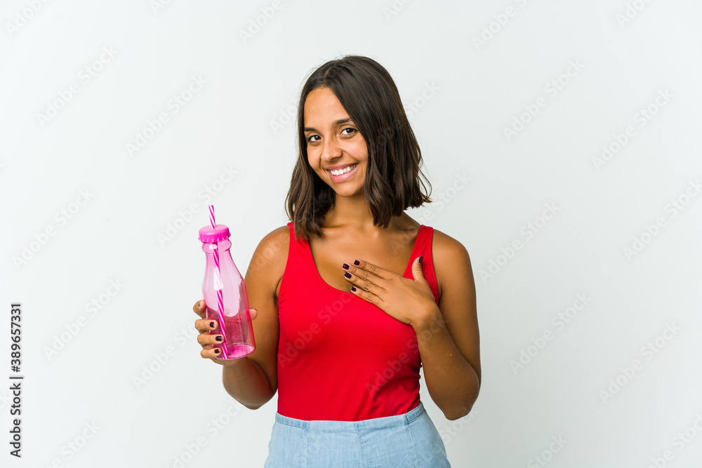 Young latin woman holding a milkshake isolated on white background Young latin woman holding a milkshake isolated on white background