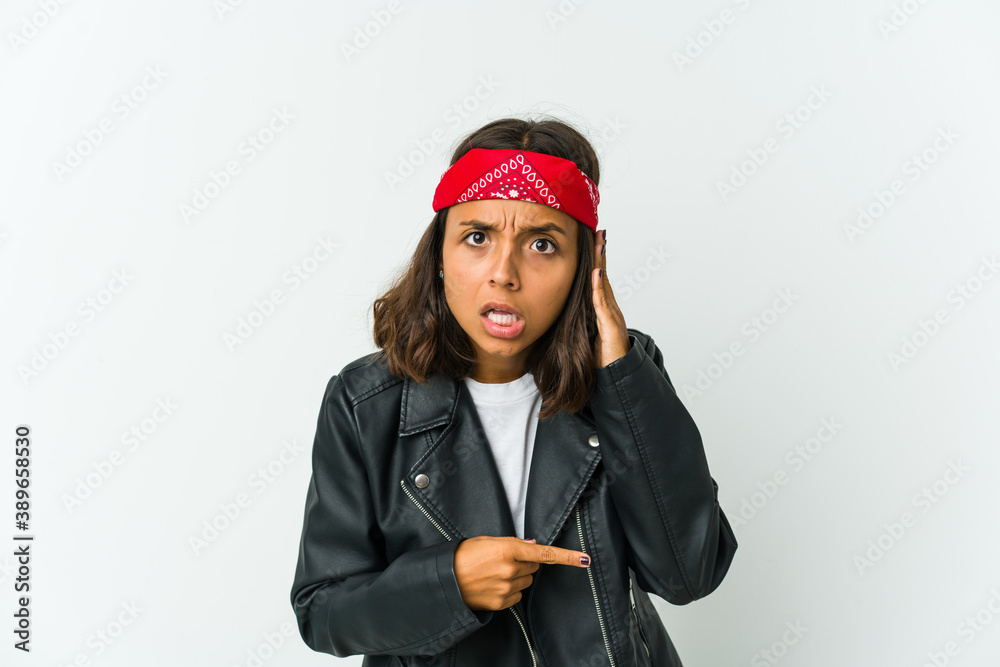 Young latin rocker woman isolated on white background