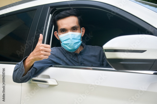 Asian man wear face mask sitting in car protect coronavirus covid 19 © Suriyo