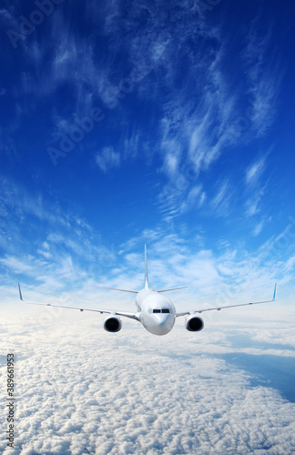 Landscape with airplane is flying in the blue sky and white clouds.