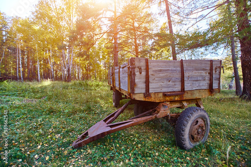 Tractor trailer. An old trailer sits on a green lawn.