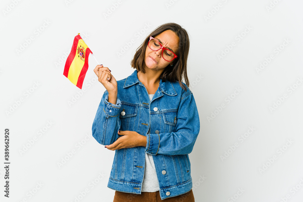 Young spanish woman holding a flag isolated on white background Young spanish woman holding a flag isolated on white background