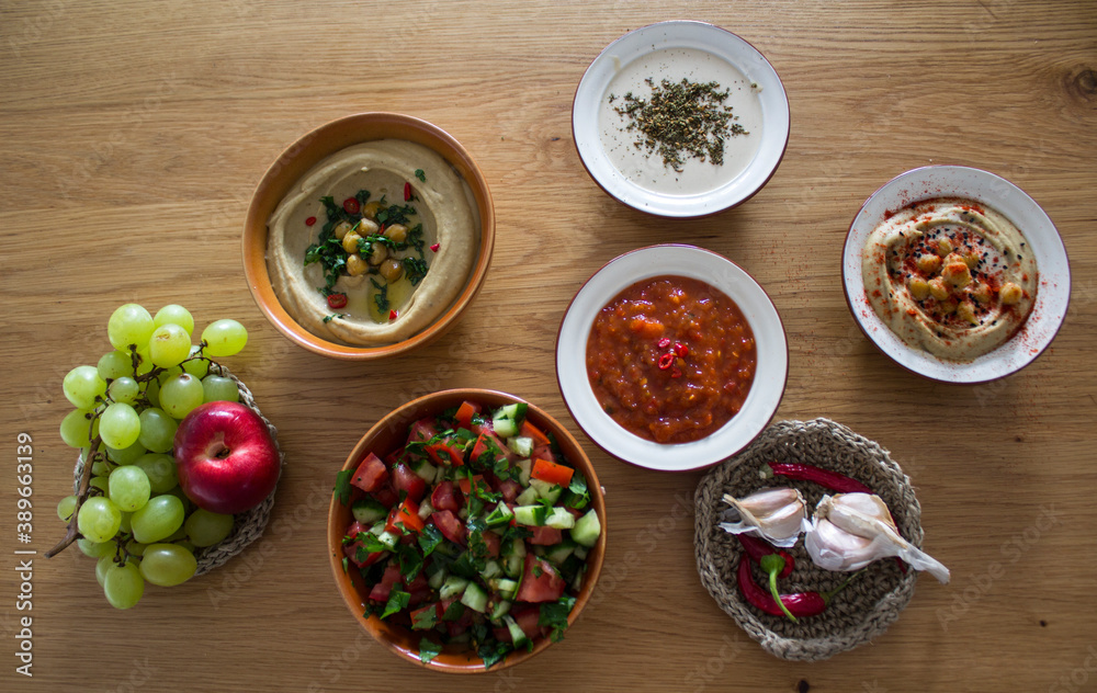 Food of Israel on a table. Top view photo of fresh made hummus, falafels and pita bread. Healthy eating concept. 