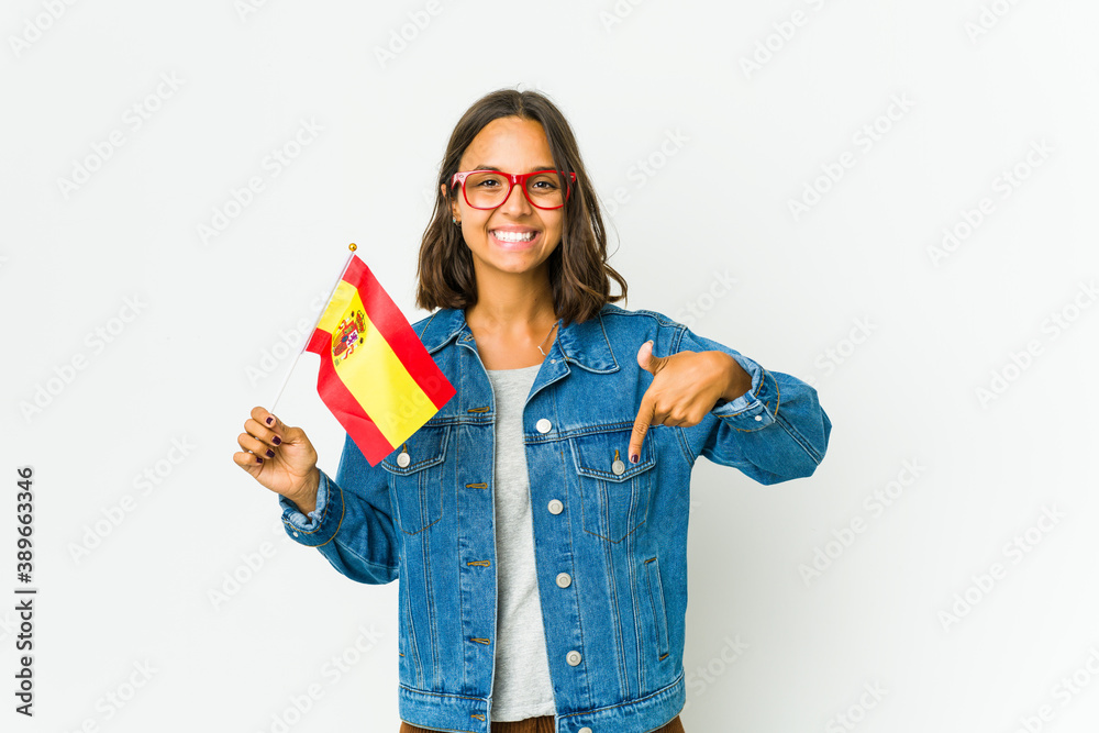 Young spanish woman holding a flag isolated on white background Young spanish woman holding a flag isolated on white background