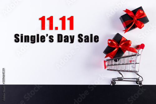 11.11 Singles day sale. Black gifts and shopping cart with text for advertiser.