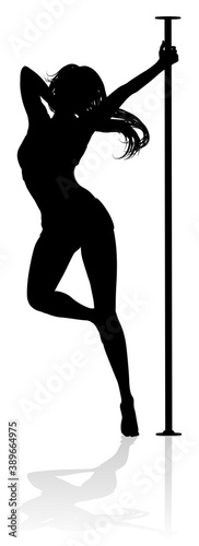 A woman pole dancer exercising for fitness in silhouette