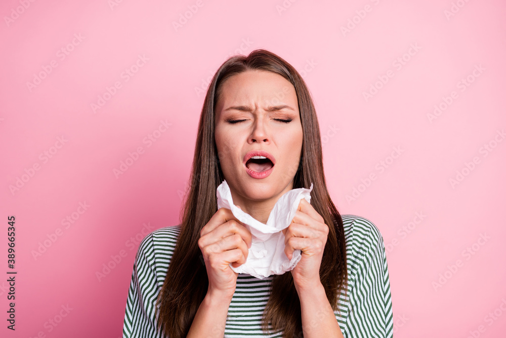 Portrait of sick young brunette woman hold napkin feel ill dress shirt fashionable clothing isolated on pink color background Portrait of sick young brunette woman hold napkin feel ill dress shirt fashionable clothing isolated on pink color background