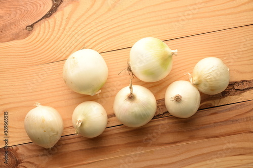 Juicy organic white onion  close-up  on a wooden table.