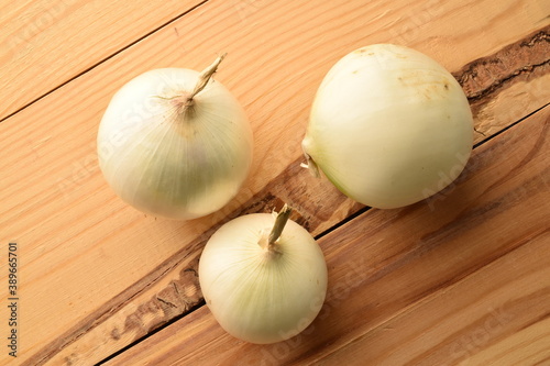 Juicy organic white onion  close-up  on a wooden table.