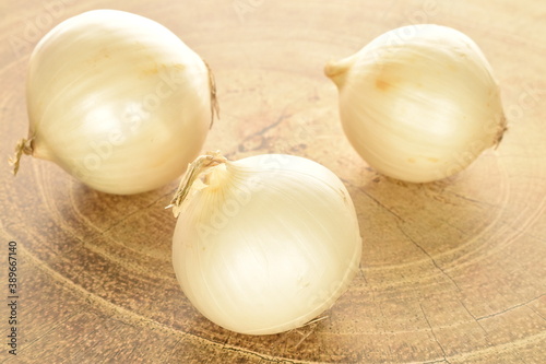Ripe white organic onions  close-up  on a wooden table.