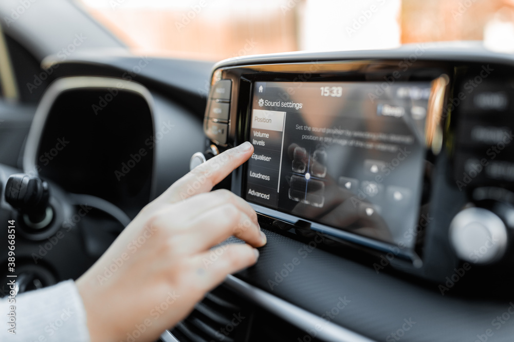 Interior view of brand new car. Driver adjust car's language on the control panel.