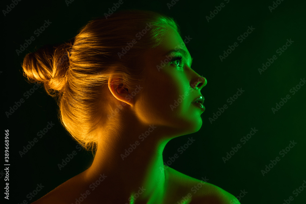 Passioned. Portrait of female fashion model in neon light on dark studio background. Beautiful caucasian woman with trendy make-up and well-kept skin. Vivid style, beauty concept. Close up. Copyspace
