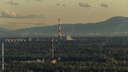 Chimneys of Silesian factories against the background of the Skrzyczne mountains in the Silesian Beskids