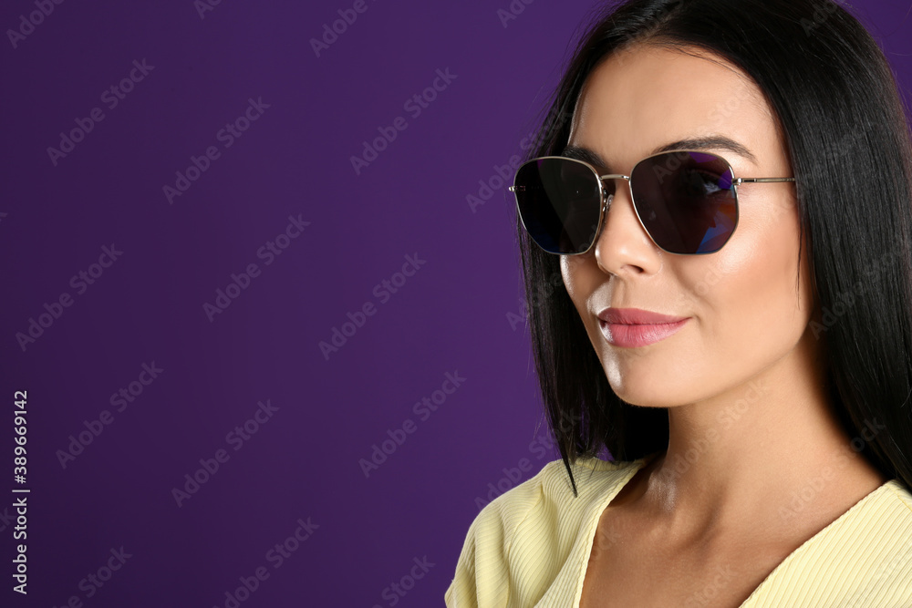Beautiful woman wearing sunglasses on purple background, closeup. Space for text Beautiful woman wearing sunglasses on purple background, closeup. Space for text
