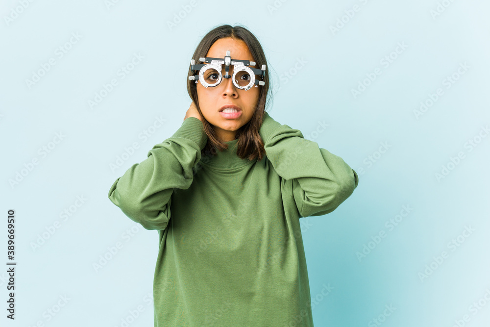 Young oculist latin woman over isolated background Young oculist latin woman over isolated background