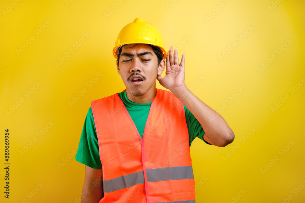 Asian constructor man hearing to rumor or gossip Asian constructor man hearing to rumor or gossip